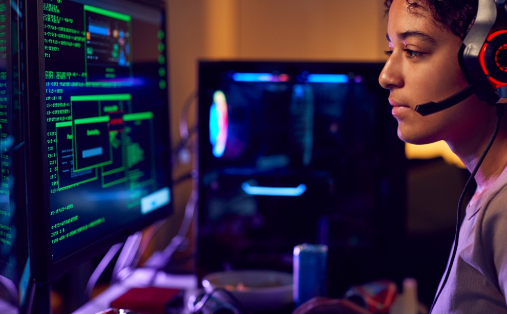 Female Teenage Hacker Sitting in Front of Computer Screens Bypassing Cyber Security